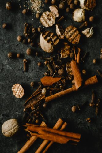 20 Powerful Herbs for Financial Prosperity: How to Use Herbs to Attract Money 12 dried herbs and spices on black surface