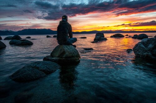 Start The Lenten Season Off Right: 7 Spiritual Things To Do On Ash Wednesday 5 person sitting on rock on body of water