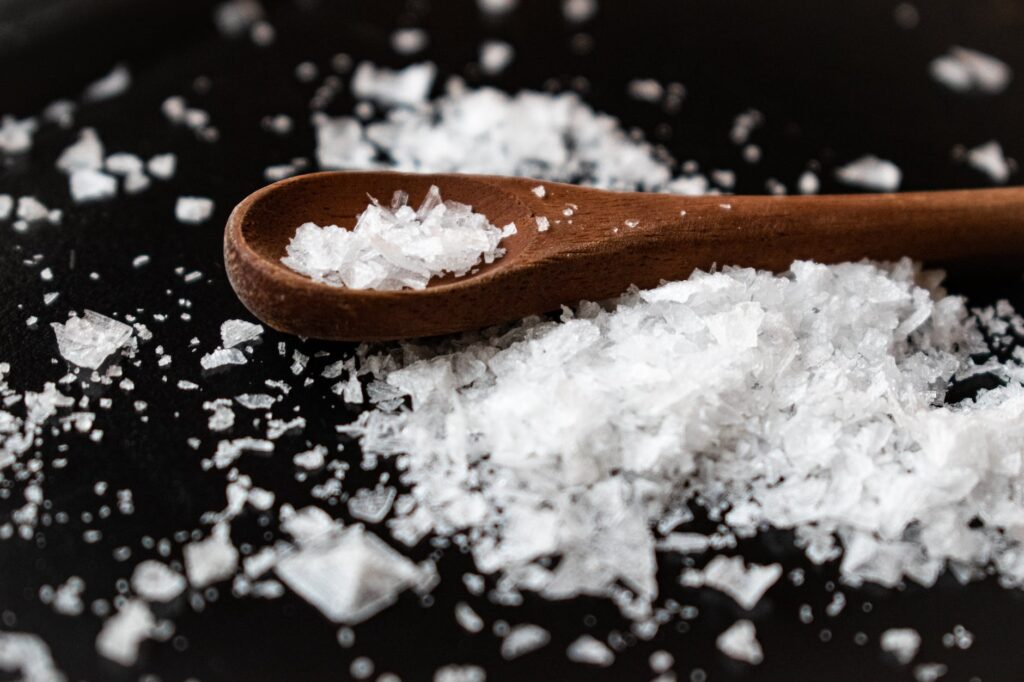 wooden spoon with salt on table