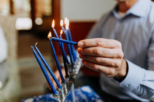 close up photo of person lighting a candle