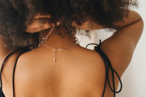 woman wearing gold chain necklace